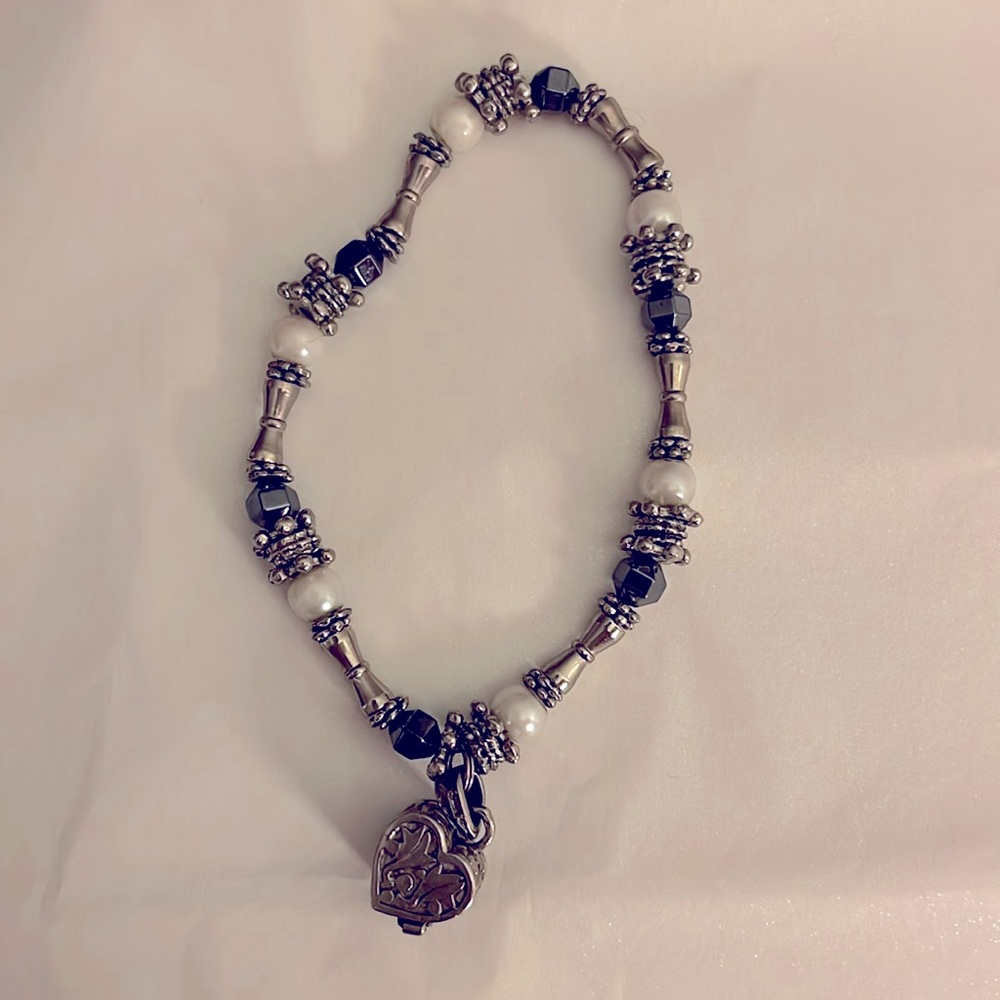 Silver, grey and white bracelet with heart charm detail.